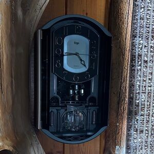 Sleek Black Rhythm  Wall Clock with moving Crystal base and bell pendilumn